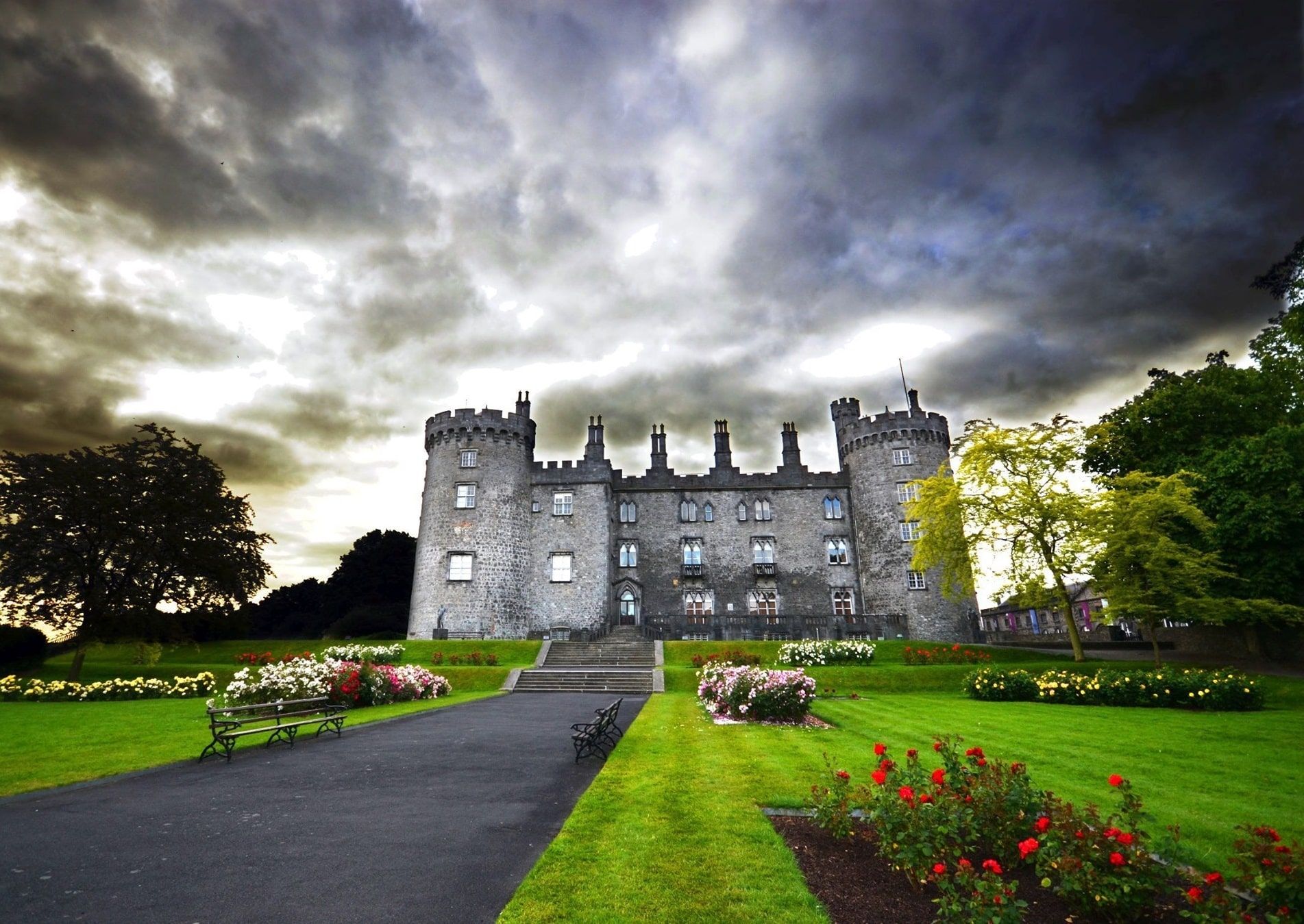 Exterior image of Kilkenny Castle from the Rosegarden with cloudy sky.