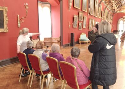 Trained guide giving a dementia inclusive tour of the Picture gallery to small group.